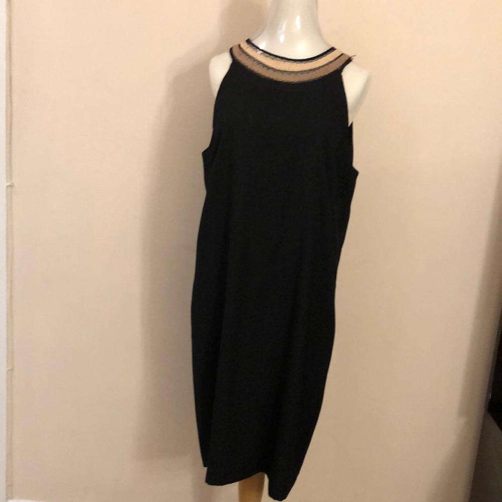 Black dress with ornament around the neck in excellent condition.